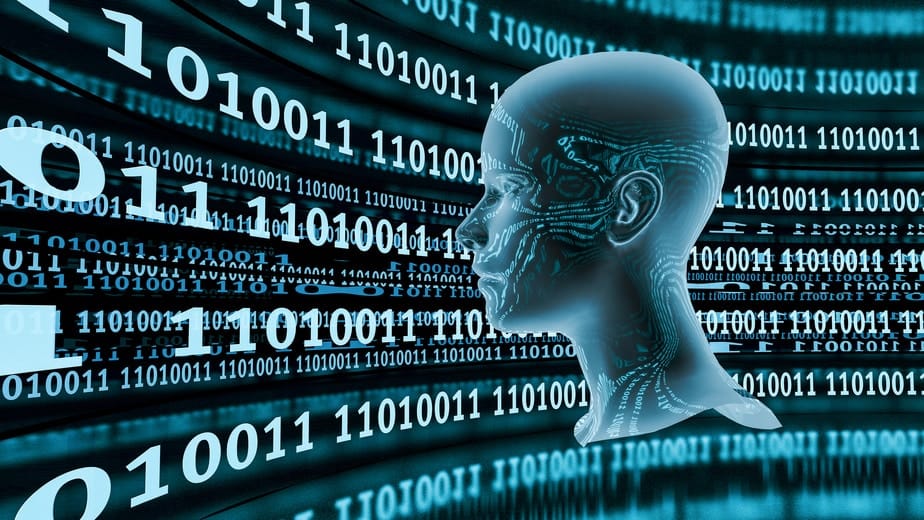 A human head looking at a projection of blue binary code.